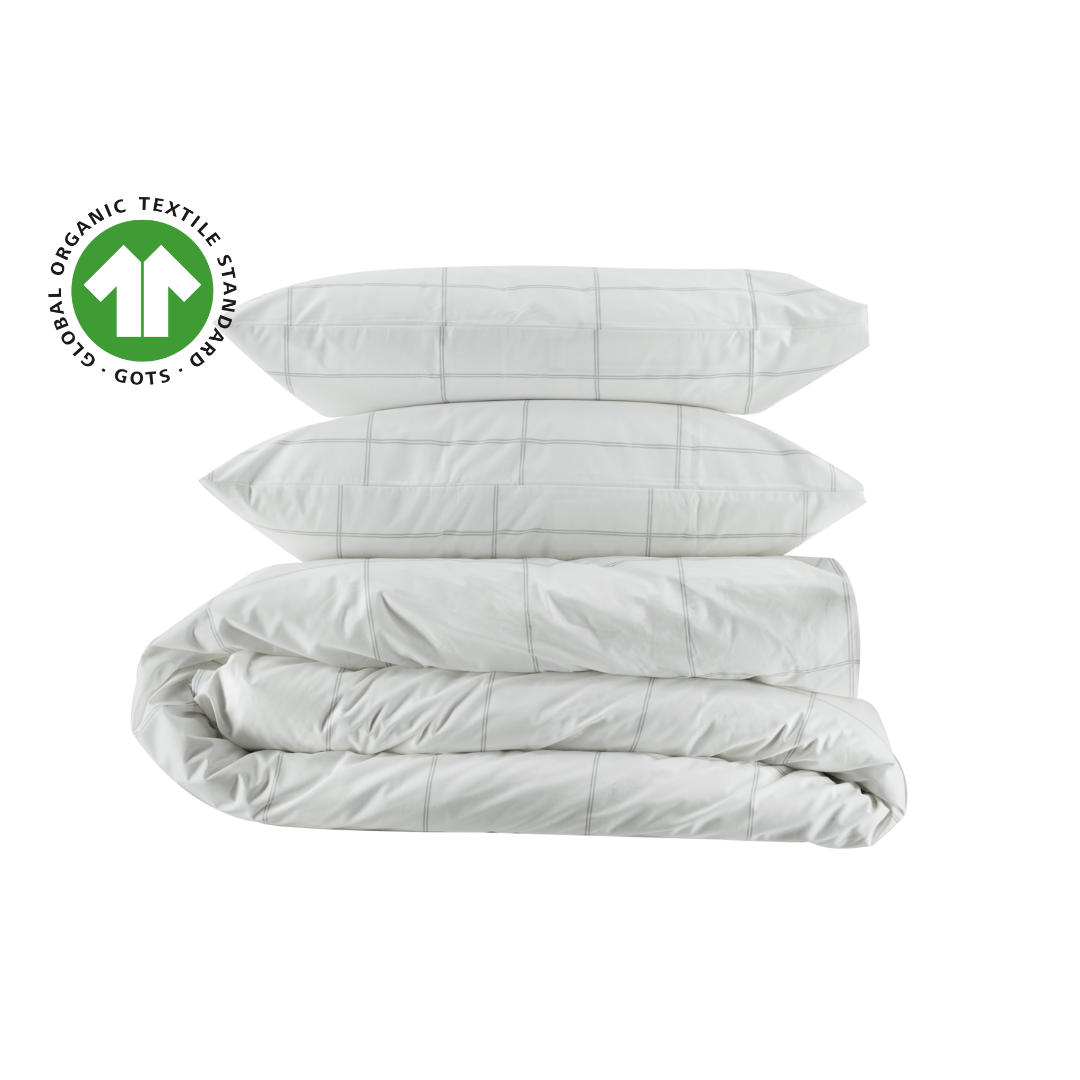 White comforter set with pillows on a white background, featuring the Global Organic Textiles (GOTS) logo.