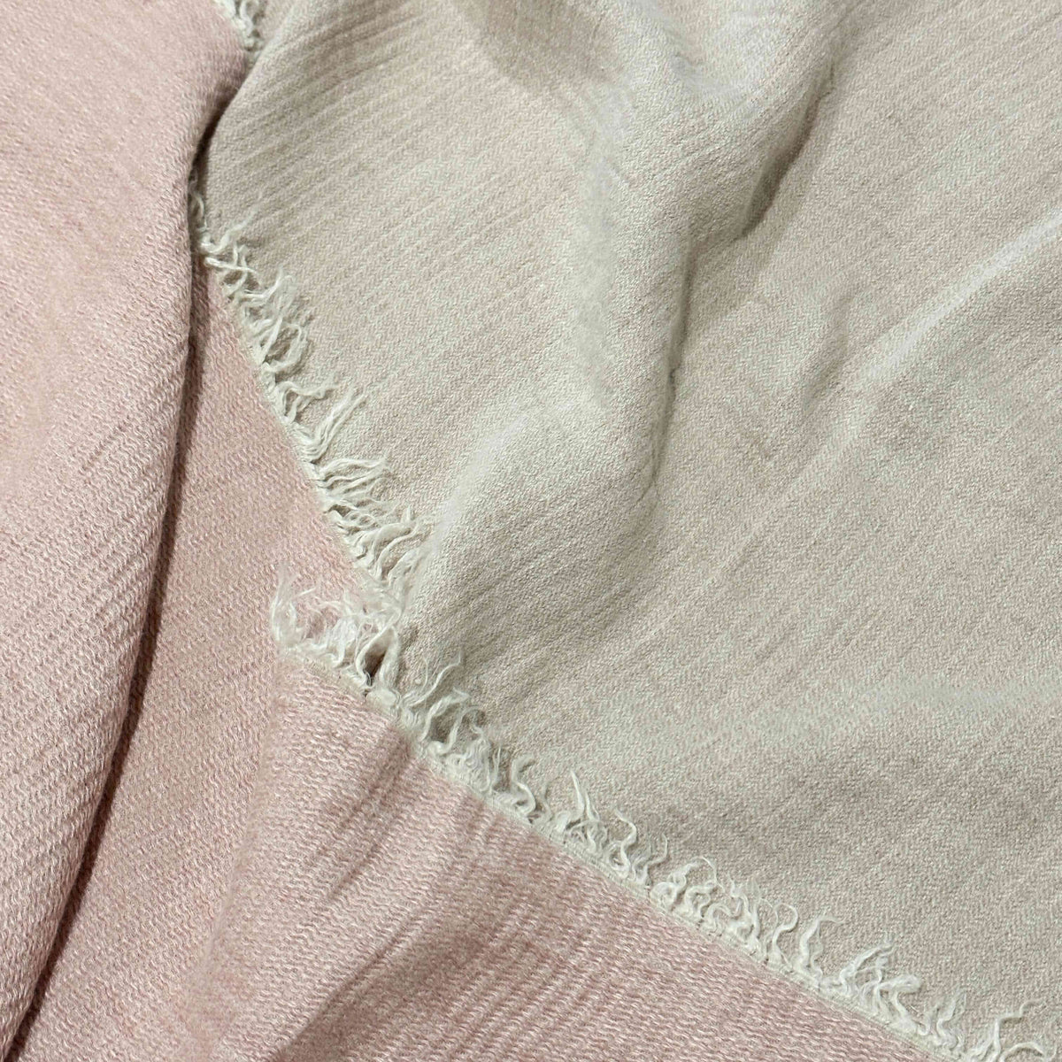 Close-up of a pink linen throw blanket  with a textured border