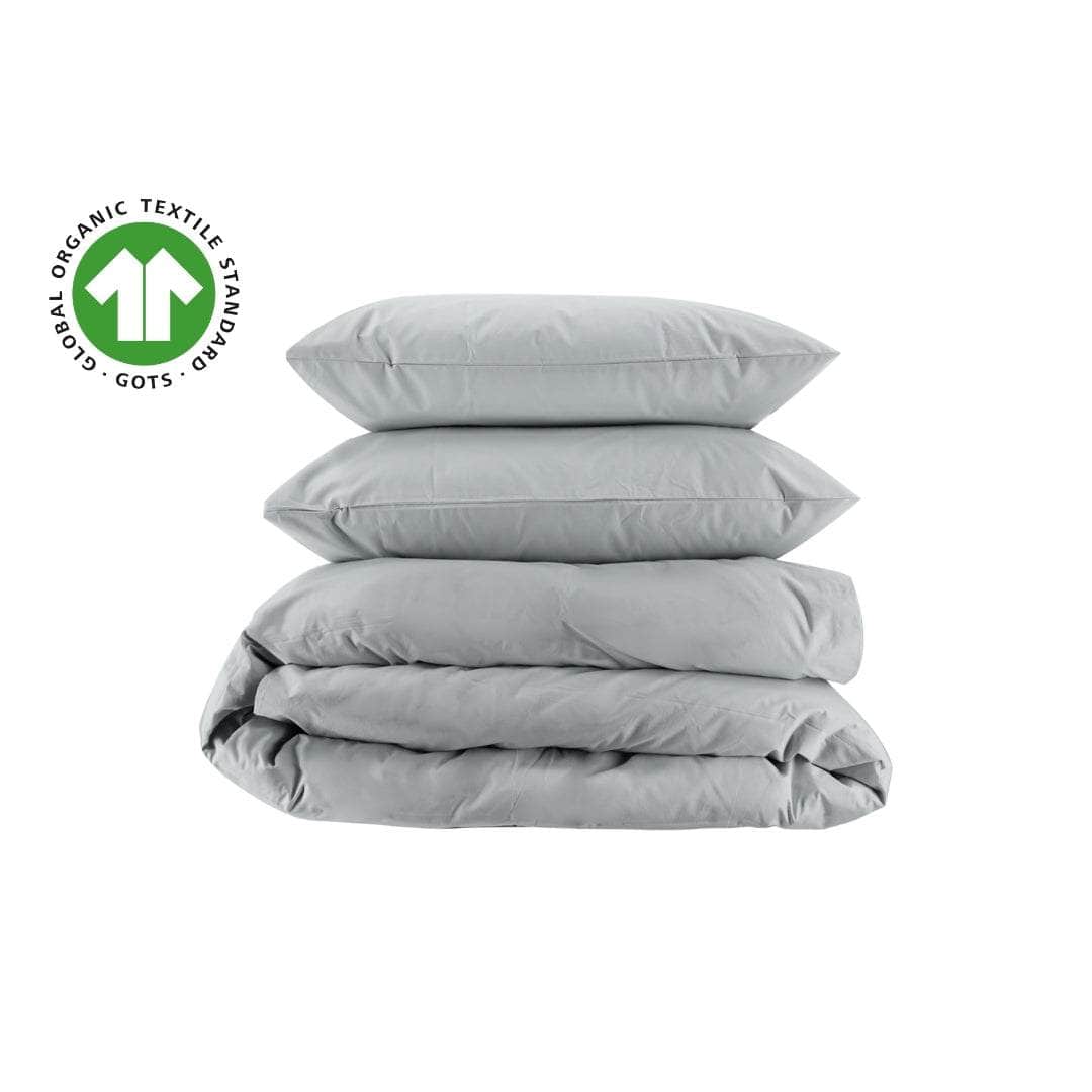 Stack of gray organic percale bedding with a Global Organic Textile Standards (GOTS) logo on a white background