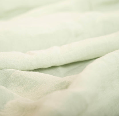 Close-up of light green fabric with a soft texture