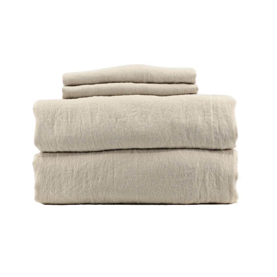 Stack of beige linen sheets on a white background